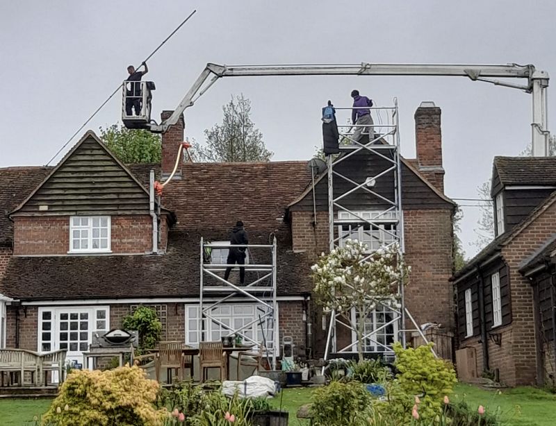 The Roof Moss Cleaners using cherry picker and scaffolding to clean roof safely and professionally in Hatfield, Hertfordshire